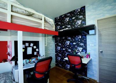 Bedroom with bunk bed, desks, and chairs