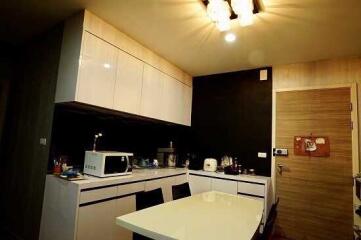 Modern kitchen with white cabinets and dining area