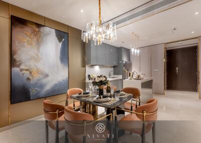 Modern dining area with a stylish table and chairs, adjacent to an open kitchen