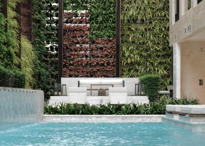 Luxurious outdoor pool area with vertical garden and seating