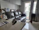 Modern living room with leather sofa and natural light