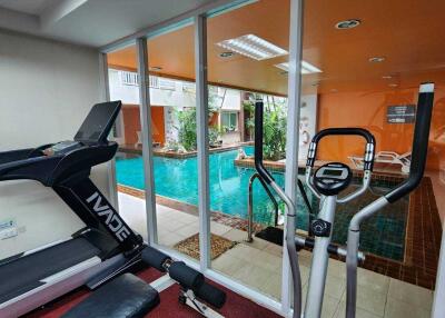 Home gym with indoor pool view