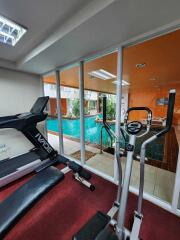 Home gym with indoor pool view