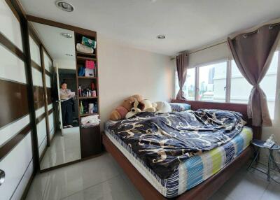 Modern bedroom with large windows and ample storage
