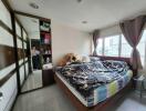 Modern bedroom with large windows and ample storage