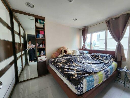 Modern bedroom with large windows and ample storage