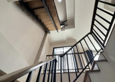 Modern staircase with metal railings and wooden steps