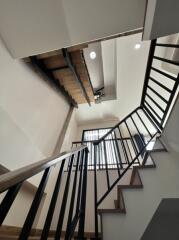 Modern staircase with metal railings and wooden steps