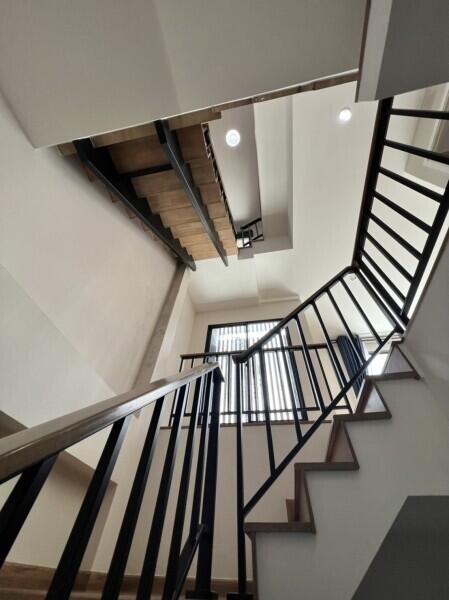 Modern staircase with metal railings and wooden steps