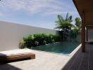 Modern outdoor pool area with lounge chairs and greenery