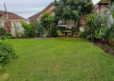 Spacious garden with lawn and seating area