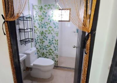 Bathroom with modern fixtures and patterned shower area