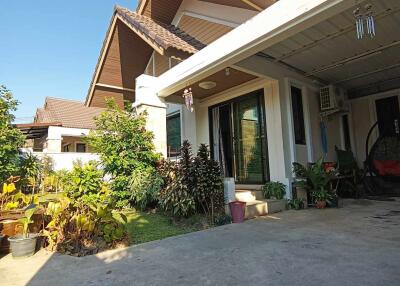 Exterior view of a house with a driveway and garden