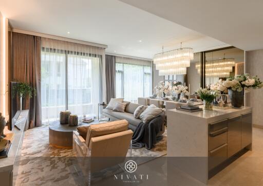 Modern and elegantly furnished living room with large windows and stylish decor