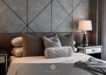 Cozy bedroom with modern decor, textured headboard, and bedside lamps