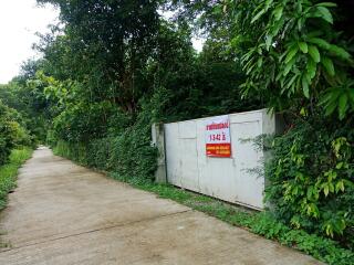 Secure gated entrance surrounded by lush greenery