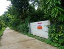 Secure gated entrance surrounded by lush greenery