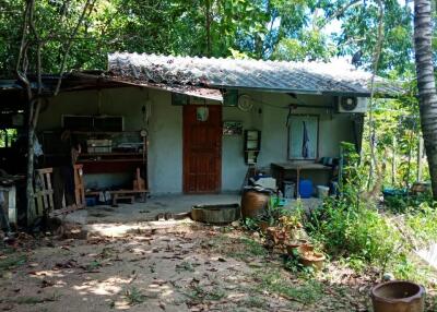 Exterior of a rustic building with outdoor workspace