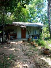 Exterior of a rustic building with outdoor workspace