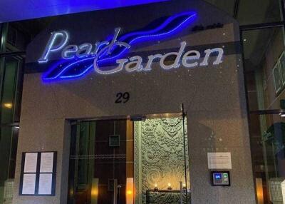 Elegant building entrance with Pearl Garden sign