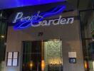 Elegant building entrance with Pearl Garden sign