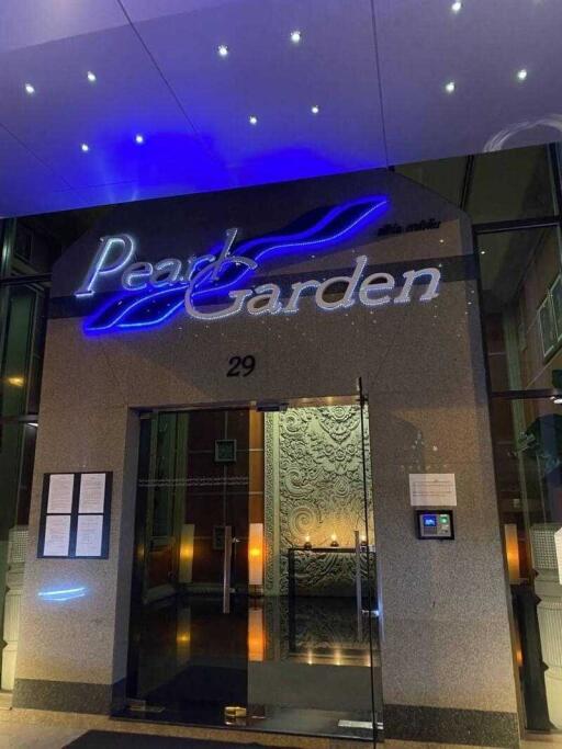 Elegant building entrance with Pearl Garden sign