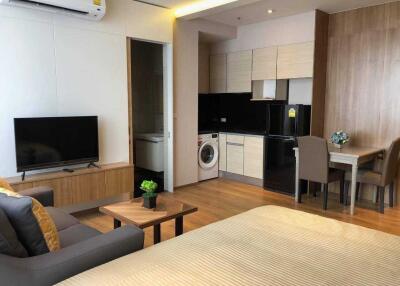 Studio apartment with open living area, kitchen, and dining space
