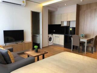 Studio apartment with open living area, kitchen, and dining space