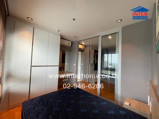 Bedroom with bed, wardrobe, and air conditioning units