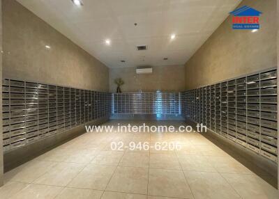 Mailroom with numerous mailboxes and tiled floor.