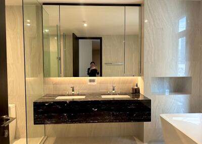 Modern bathroom with dual sinks and large mirror