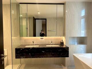 Modern bathroom with dual sinks and large mirror