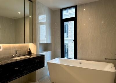 Modern bathroom with bathtub and sink.