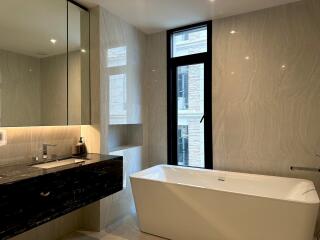 Modern bathroom with bathtub and sink.