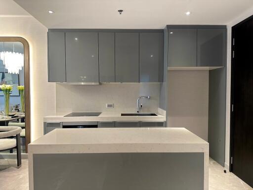 Modern kitchen with grey cabinets and white countertops