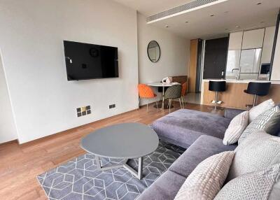 Living room with modern furnishings and open kitchen