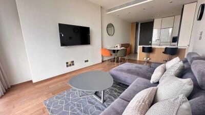 Living room with modern furnishings and open kitchen