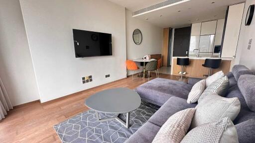 Living room with modern furnishings and open kitchen