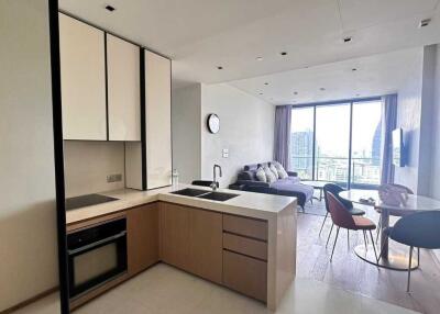 Modern apartment living area with open kitchen and dining space