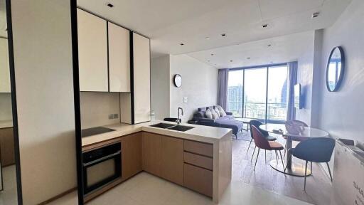 Modern apartment living area with open kitchen and dining space