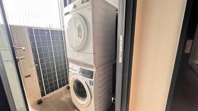 Compact laundry room with stacked washer and dryer units