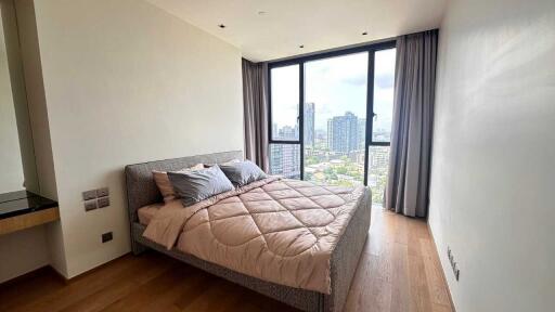 Modern bedroom with large window and city view