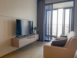 Modern living room with a wall-mounted TV and a comfortable sofa