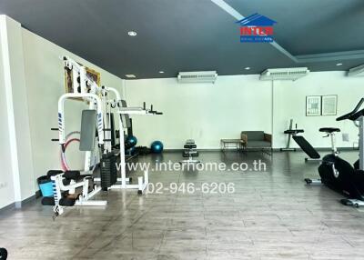 Well-equipped gym with exercise machines and weights