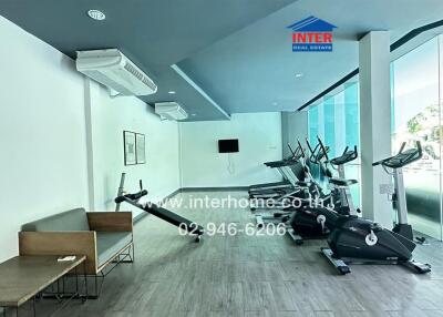 Modern gym with exercise equipment and seating area