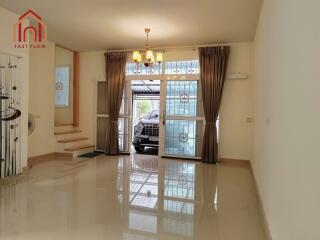 Living room with bright lighting and view of garage