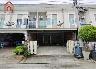 Front view of the residential building with parking space and small garden