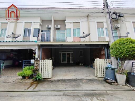 Front view of the residential building with parking space and small garden