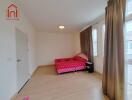 bedroom with a red bed and large windows