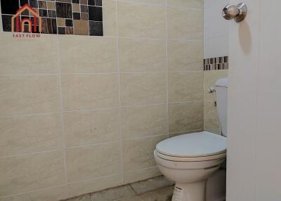 Bathroom with tiled walls and toilet